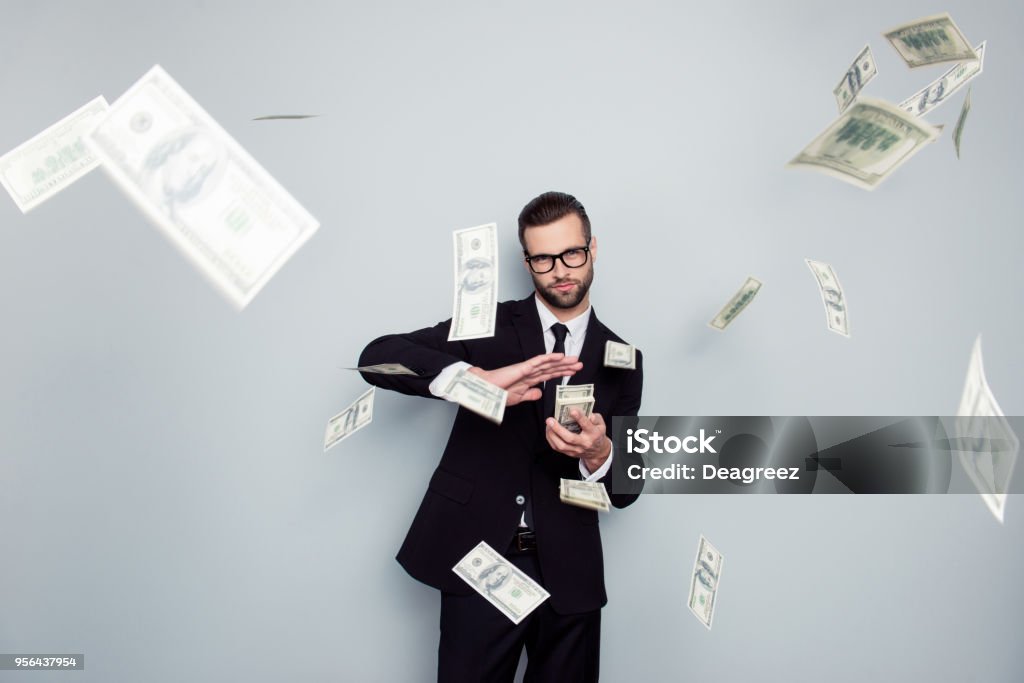 Spectacles jackpot entrepreneur economist banker chic posh manager jacket concept. Handsome confident cunning clever wealthy rich luxury guy holding wasting stack of money isolated on gray background Currency Stock Photo