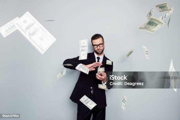 Spectacles Jackpot Entrepreneur Economist Banker Chic Posh Manager Jacket Concept Handsome Confident Cunning Clever Wealthy Rich Luxury Guy Holding Wasting Stack Of Money Isolated On Gray Background Stock Photo - Download Image Now