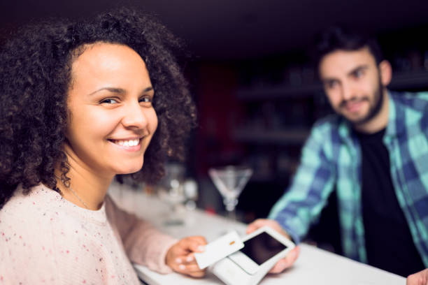 istock Smiling lady paying with credit card 956441674