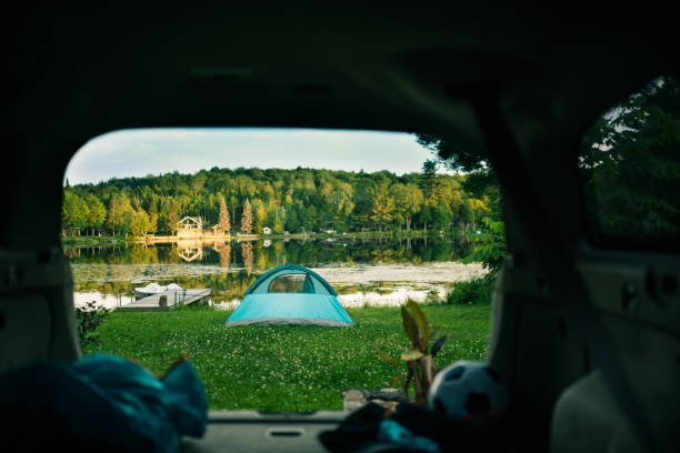 istock Camping tent is setup by the lake 956445926