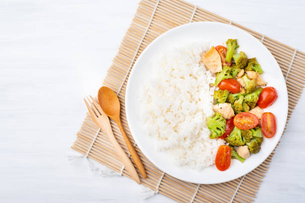 istock Fried broccoli with tomatoes, chicken and cooked rice 956448766