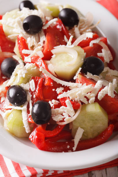 istock Bulgarian Shopska salad vegetables with cheese macro. vertical 956449302