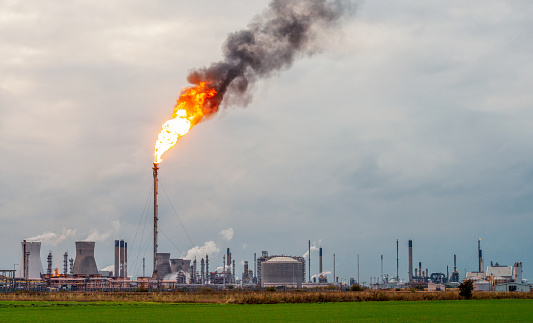 Flames and smoke rising from a flare stack at Grangemouth oil refinery and petrochemical plant in Central Scotland.