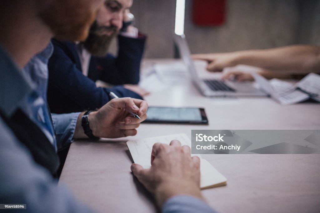 Close up of a man taking notes on a business meeting Accountancy Stock Photo