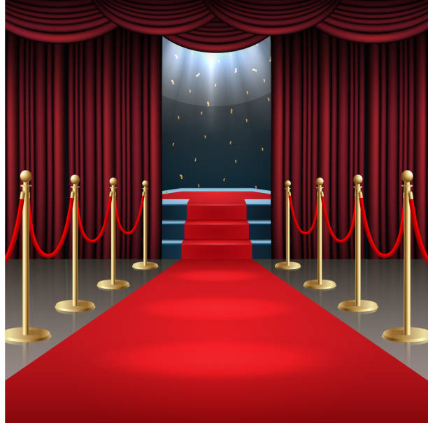 istock Podium with red carpet and curtain in glow of spotlights 956459786