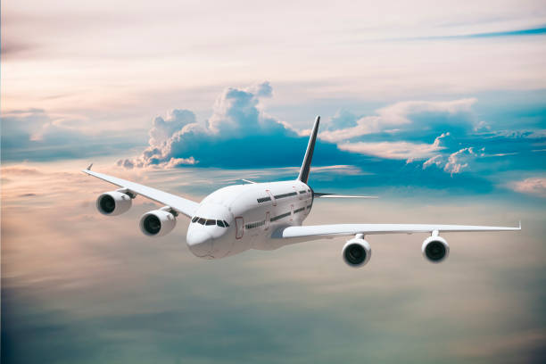istock 3d commercial airplane against perfect clear blue sky 956461134