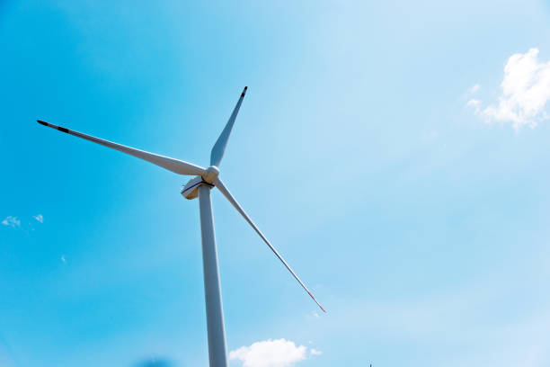 istock Wind turbine in blue sky 956463128