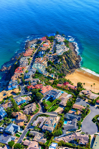 Luxury mansions on the cliffs of a small peninsula in the beautiful community of Laguna Beach in southern Orange County, California shot from an altitude of about 1500 feet.
