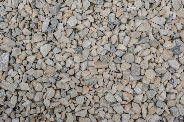 istock Gravel and pebbles background pattern, small and big sand 956477296