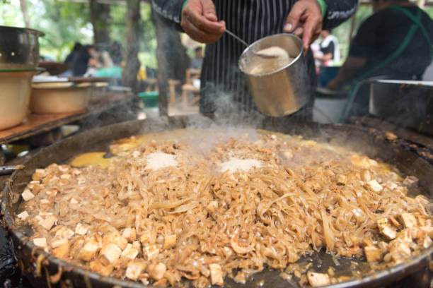 istock Close up movement hand the chef cooking Pad Thai in a pan. 956477992