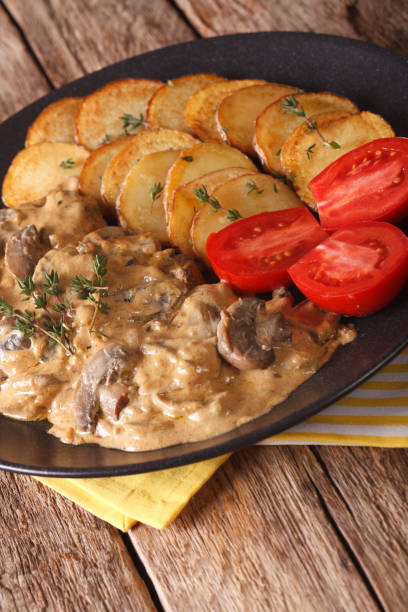 istock Steak with mushrooms and roasted potatoes close-up. vertical 956478502