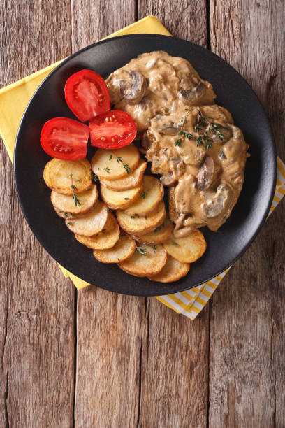 istock Diana steak garnished with fried potatoes close-up. Vertical  top view 956478782
