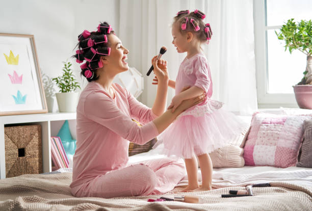 istock Mom and child doing hair 956486988
