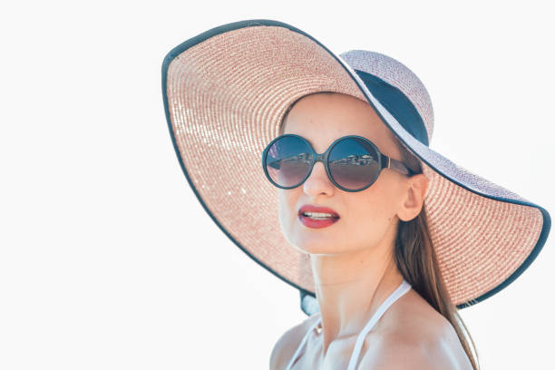 istock Woman with sun hat standing at the beach 956488268