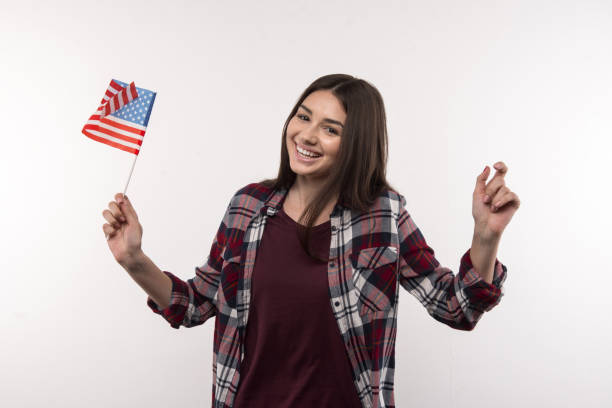 istock Nice cheerful woman holding the US flag 956489546