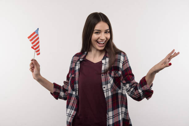 istock Joyful young woman holding the US symbol 956489582