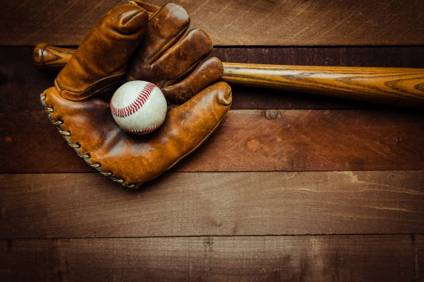 istock Vintage baseball gear on a wooden background 956490742