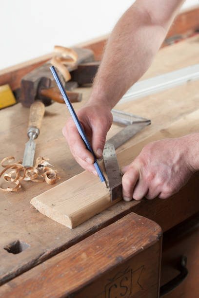 istock carpenter drawing on a wooden board.copy space 956496662