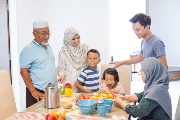 Malay family preparing food ingredients Malay family prepares food for dinner at home malay stock pictures, royalty-free photos & images