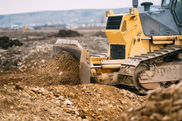 istock highway construction site close up with industrial machinery, excavator and bulldozer working 956509244
