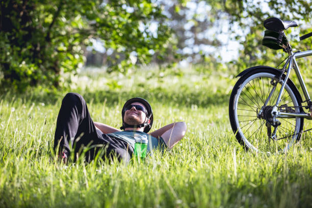 istock The cyclist lies in the grass 956509248