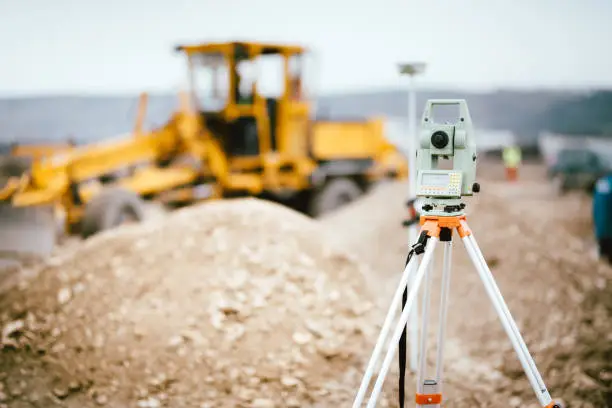 Photo of Surveyor equipment GPS system or theodolite outdoors at highway construction site. Surveyor engineering with total station