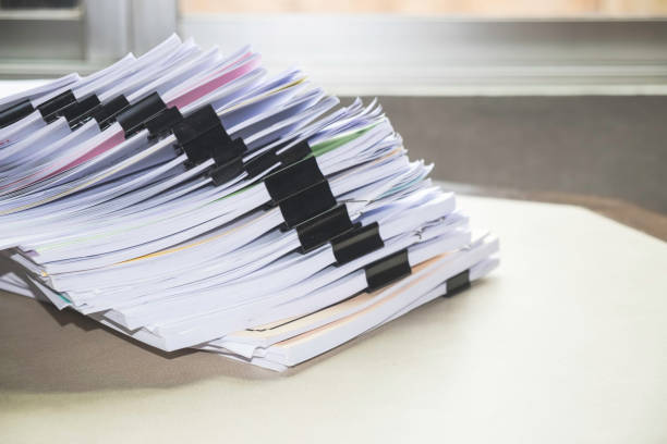 istock Pile of unfinished documents on office desk, Stack of business paper 956512520