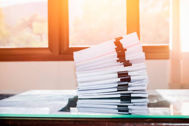istock Pile of unfinished documents on office desk, Stack of business paper 956512526