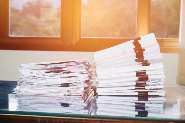 istock Pile of unfinished documents on office desk, Stack of business paper 956512532