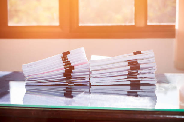 istock Pile of unfinished documents on office desk, Stack of business paper 956512756