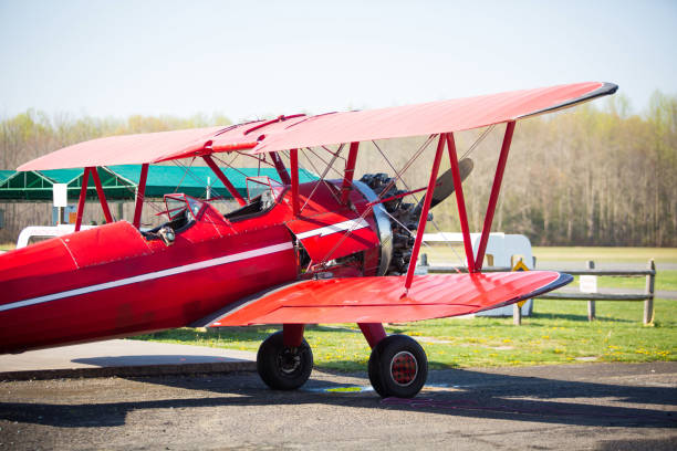 istock Vintage red plane ready to fly on the field 956514844