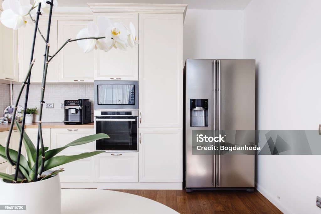 Modern appliances and new design in kitchen. Loft kitchen and apartment Refrigerator Stock Photo