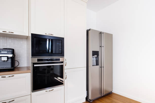 istock Modern kitchen area, wooden floor with modern refrigerator and appliances 956515774
