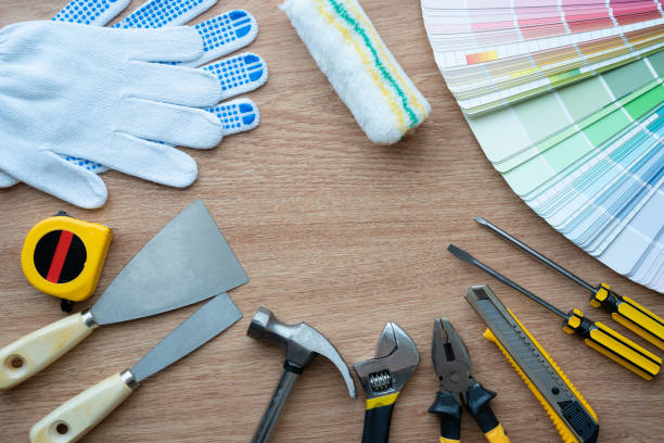 istock Painter and decorator work table with house project, Color swatches, Painting roller and paint brushes 956515998