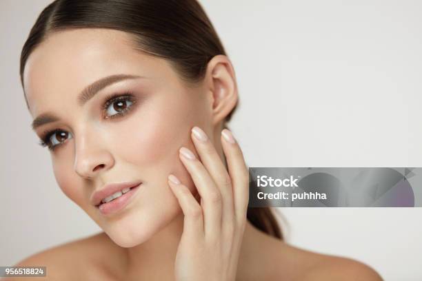 Cosmetic Face Care Young Woman Caressing Facial Skin Stock Photo - Download Image Now