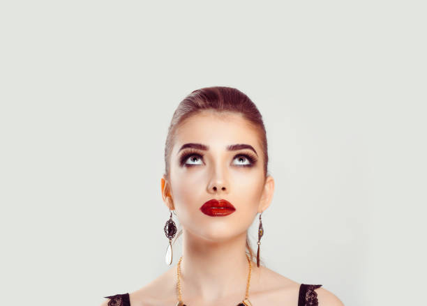 istock Young woman looking up upwards 956520990
