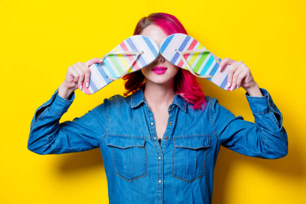istock girl holding a colored flip flops sandals 956527500