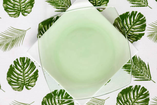 istock Palm leaves tablecloth and plate 956543362