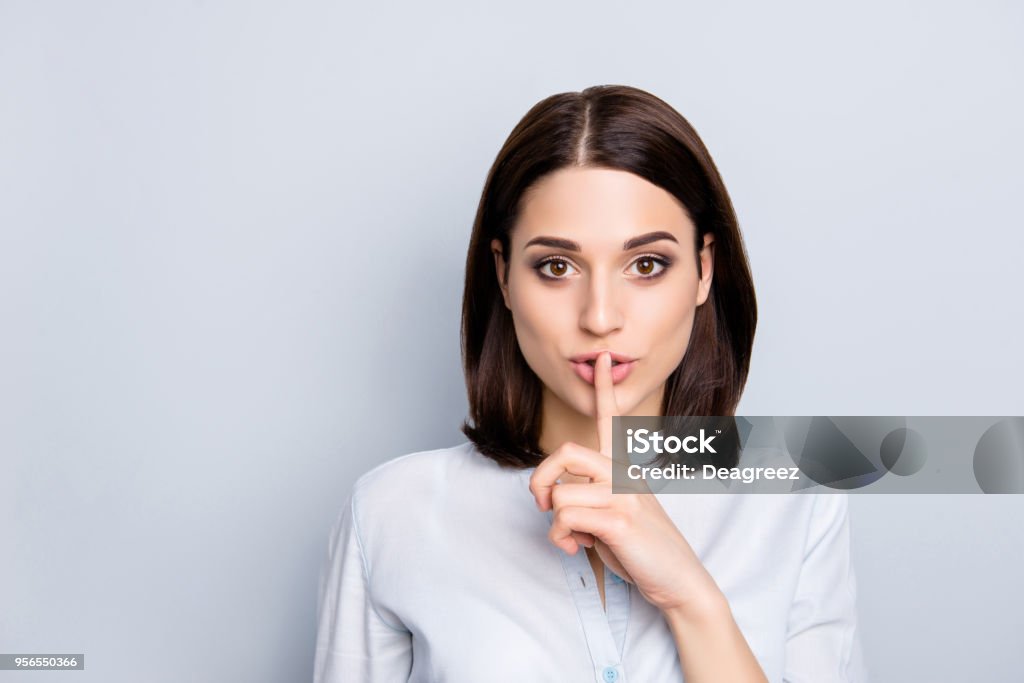 Shh shy sly people person modern concept. Close up portrait of cute lovely attractive uncertain unsure with stylish hairdo entrepreneur making hush gesture isolated on gray background copy-space Finger on Lips Stock Photo