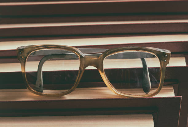 istock Old glasses on a pile of books 956558582
