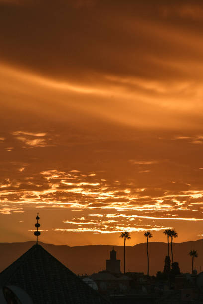Sunrise of the rooftops of Marrakech, Morocco with the Atlas Mountains in the distance.