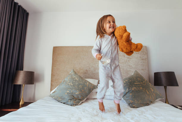 istock Little girl playing in bedroom 956559936