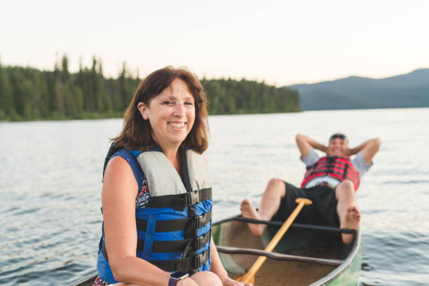 istock Senior man lying down in a canoe on the lake 956560024