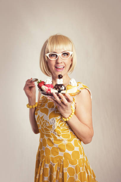 istock 60s Woman Eating Banana Split 956560108