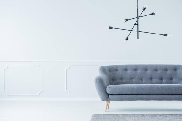 istock Rods chandelier above gray sofa 956563432