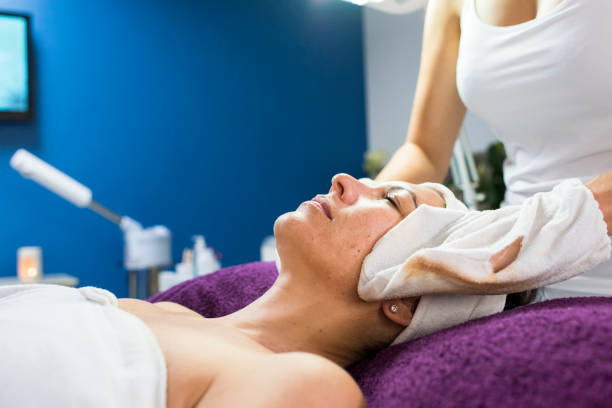 istock Beauty therapist applying a face mask to a client 956563520