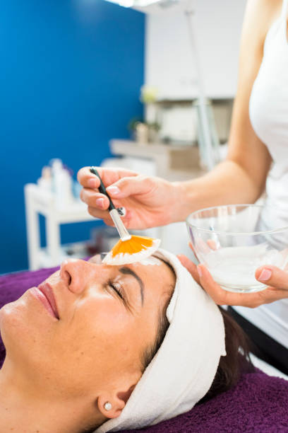 istock Beauty therapist applying a face mask to a client 956563732