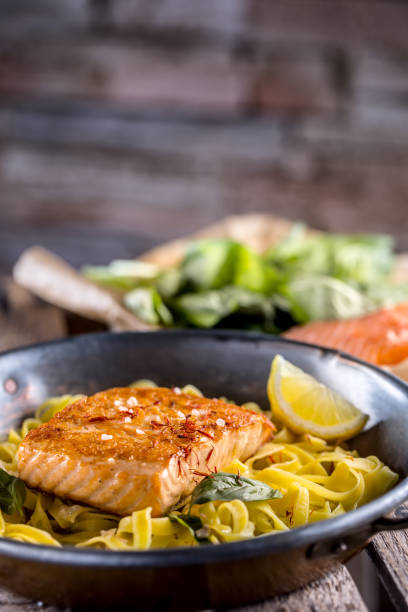 istock Pieces of roasted salmon with pasta tagliatelle lemon and basil 956565108
