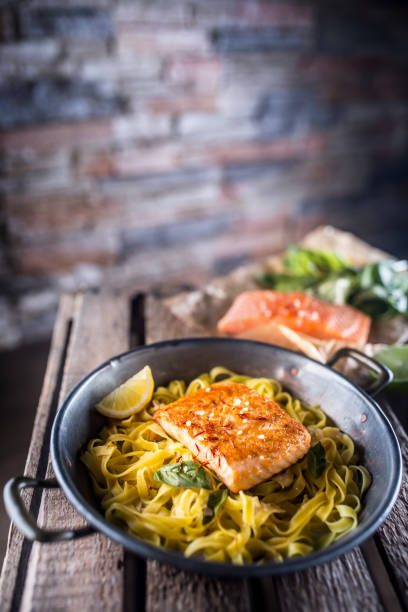 istock Pieces of roasted salmon with pasta tagliatelle lemon and basil 956565136