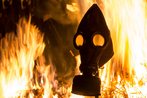 istock A gray gas mask on a contrasting blurred background of forest fires 956565344
